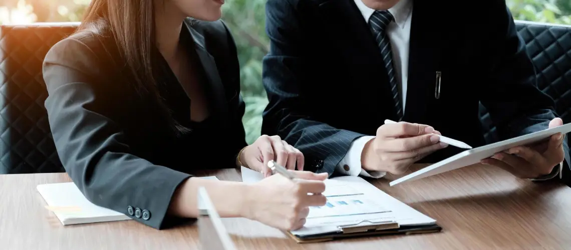 A Brisbane entrepreneur discussing business valuation reports with a consultant